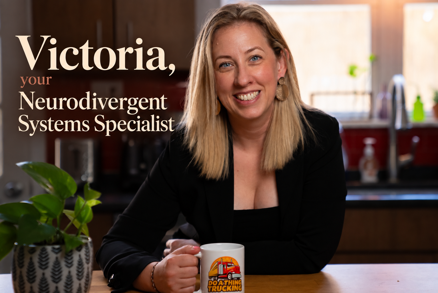 Victoria Prisco, Neurodivergent Systems Specialist, smiling at her kitchen table with a coffee mug.